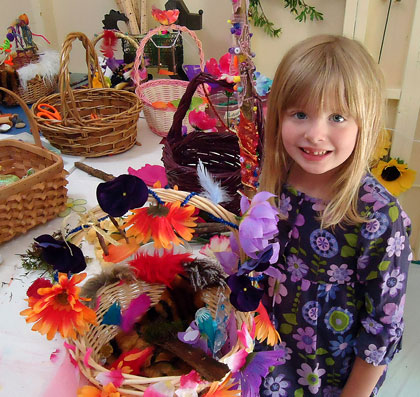 A camper proudly displays the fairy basket, fairy finger puppets, 